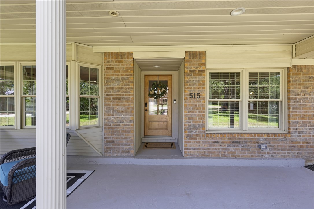 515 Crescent Drive Bryan, TX 77801 - Photo 4 of 43 Covered front porch featuring a brick facade, recessed lighting, and a entry door with glass inserts