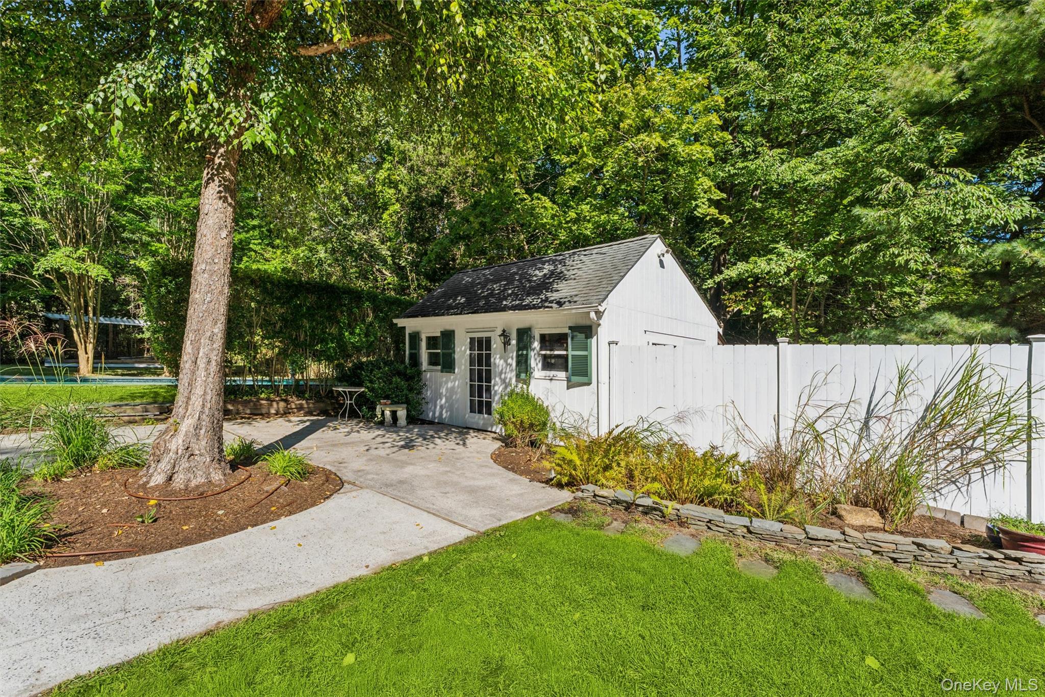 29 Squiretown Road, Unit D Hampton Bays, NY 11946 - Photo 5 of 16 Detached utility shed with a gabled roof and white siding
