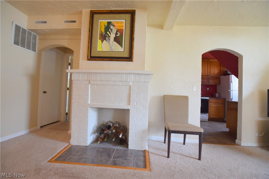 Here is that brick fireplace just waiting for your decorative touches. Door on left is closet with bathroom beyond.
