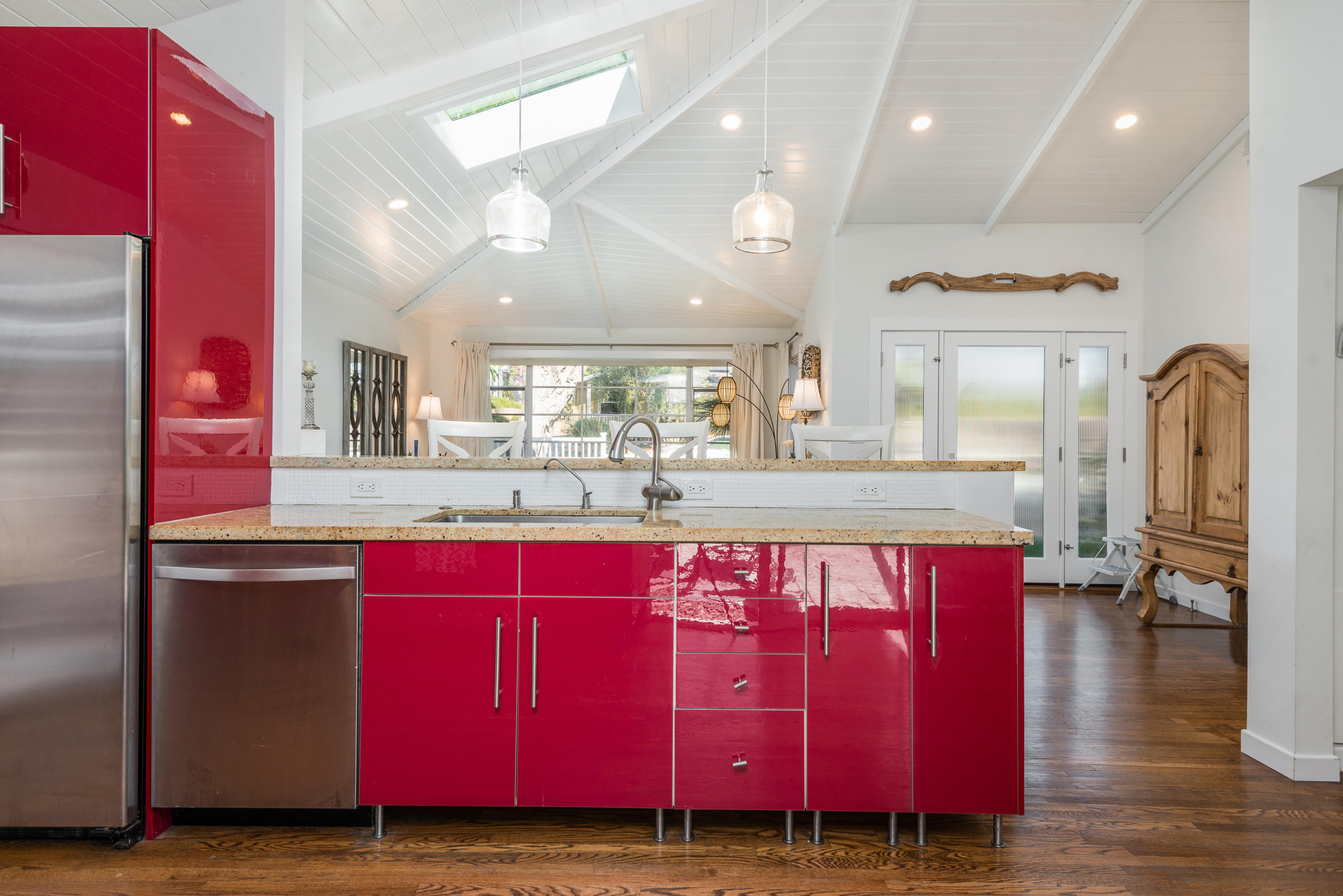 429 Terrace Road Santa Barbara, CA 93109 - Photo 7 of 15 a kitchen with stainless steel appliances kitchen island granite countertop a red stove a kitchen island a refrigerator and red cabinets