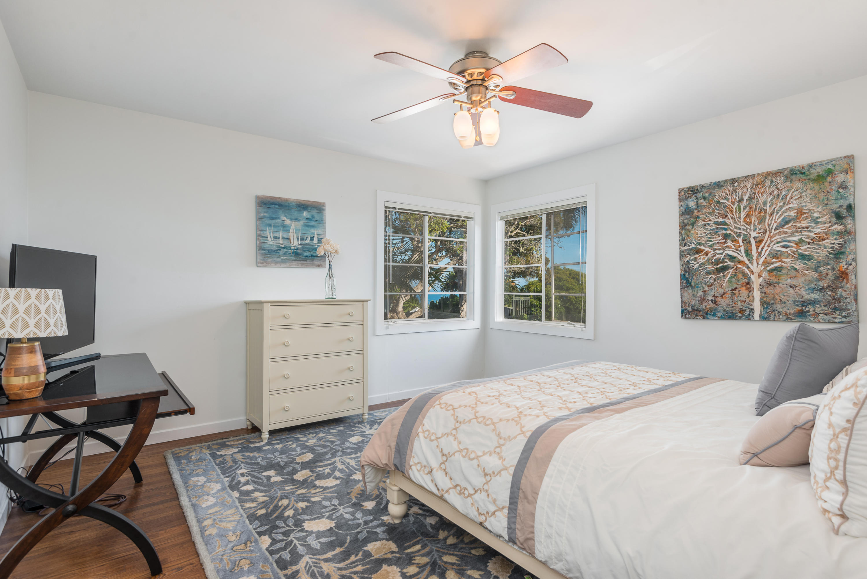 429 Terrace Road Santa Barbara, CA 93109 - Photo 8 of 15 a bedroom with a bed and a chandelier