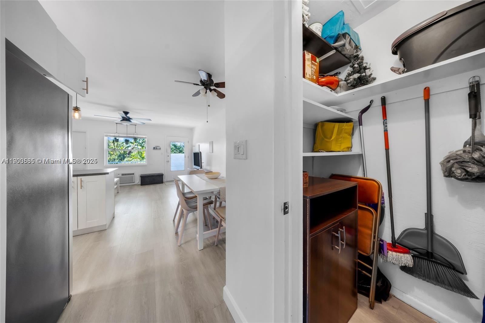 15610 Northeast 6th Avenue, Unit 33D Miami, FL 33162 - Photo 14 of 18 a view of kitchen and dining room with wooden floor