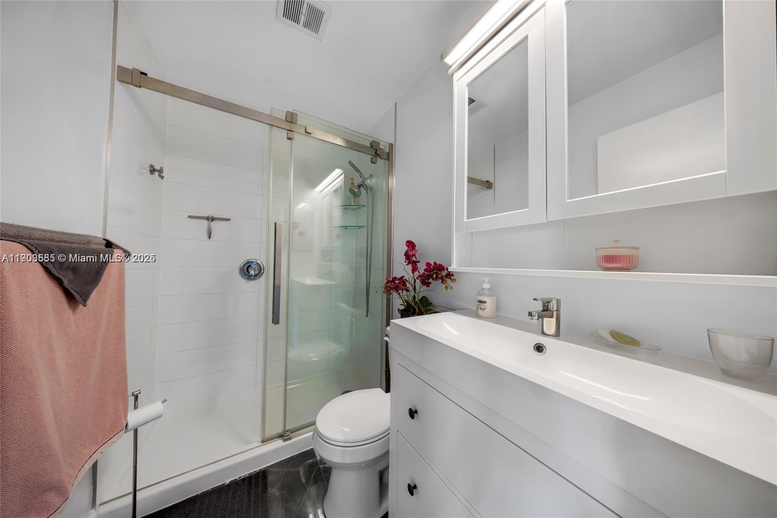 15610 Northeast 6th Avenue, Unit 33D Miami, FL 33162 - Photo 18 of 18 a bathroom with a sink toilet and shower