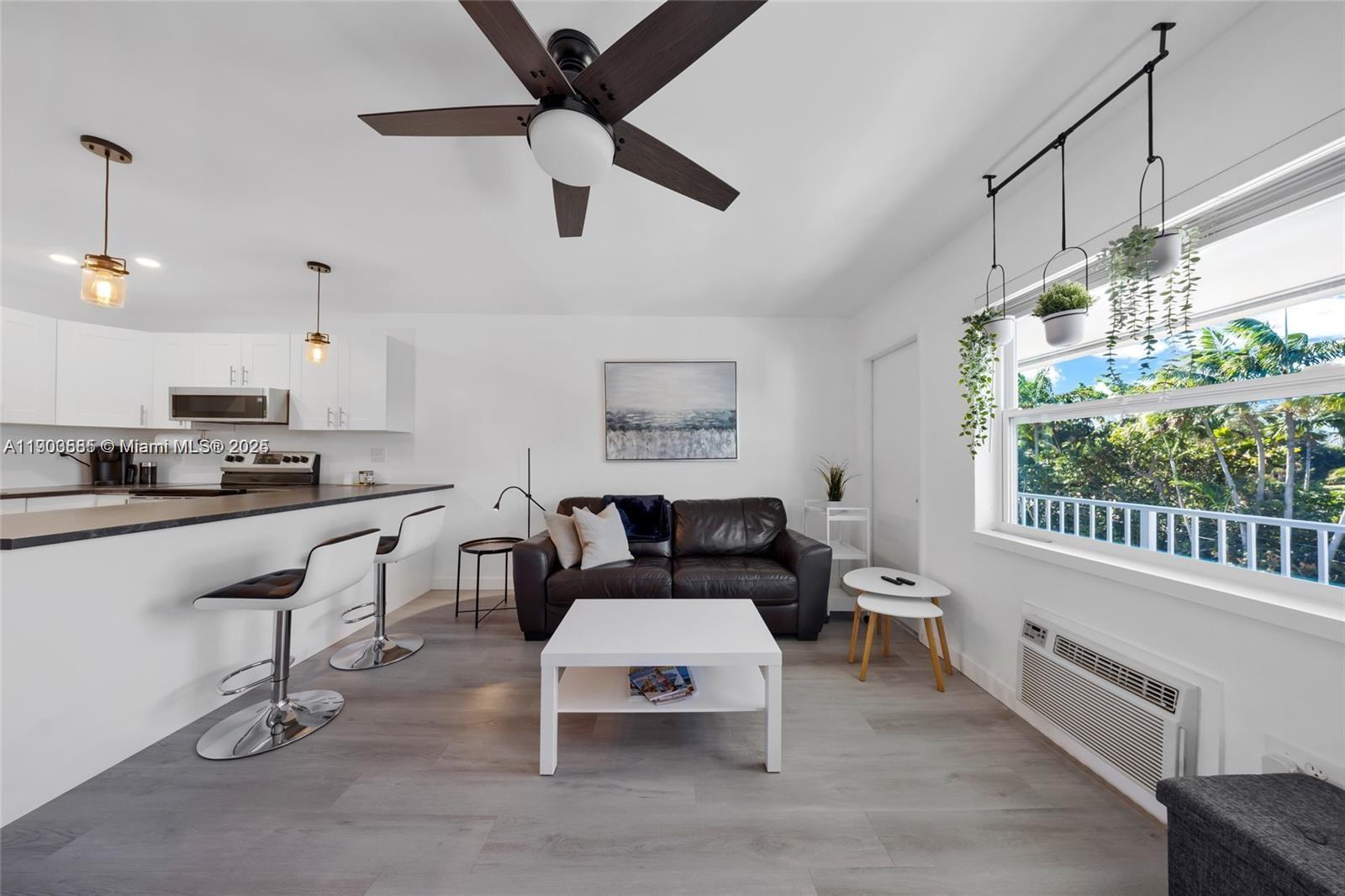 15610 Northeast 6th Avenue, Unit 33D Miami, FL 33162 - Photo 6 of 18 a living room with furniture and a window