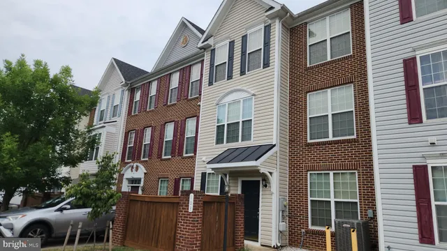 a front view of a building with a garden and plants