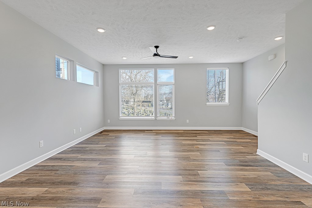 3601 Bailey Avenue Cleveland, OH 44113 - Photo 8 of 22 Spare room featuring ceiling fan, a textured ceiling, and dark hardwood / wood-style floors