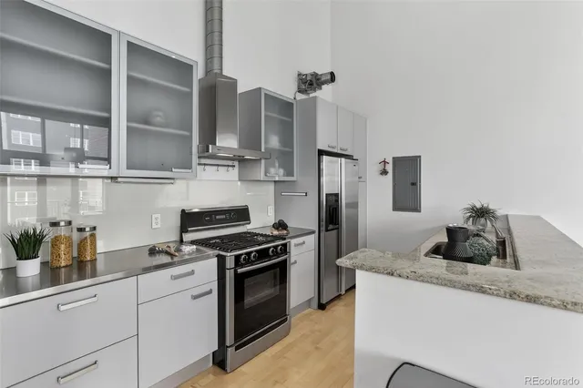 a kitchen with cabinets and stainless steel appliances