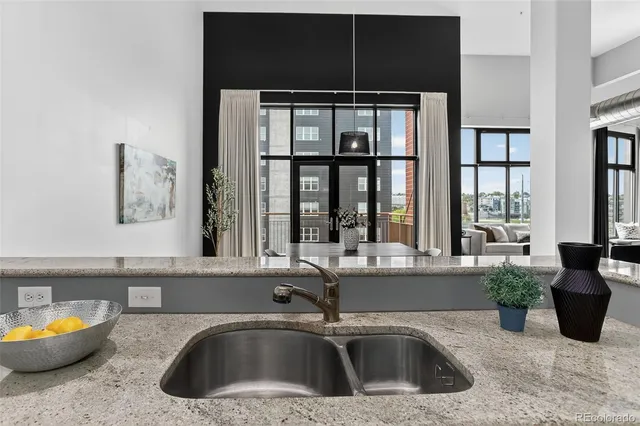 a kitchen with a sink and a large window