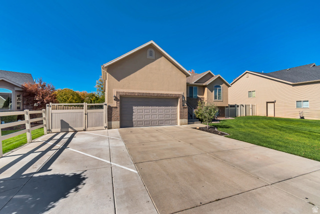 1071 Jamie-Matt Circle Layton, UT 84041 - Photo 28 of 28 Ranch-style home with a gate, stucco siding, and concrete driveway