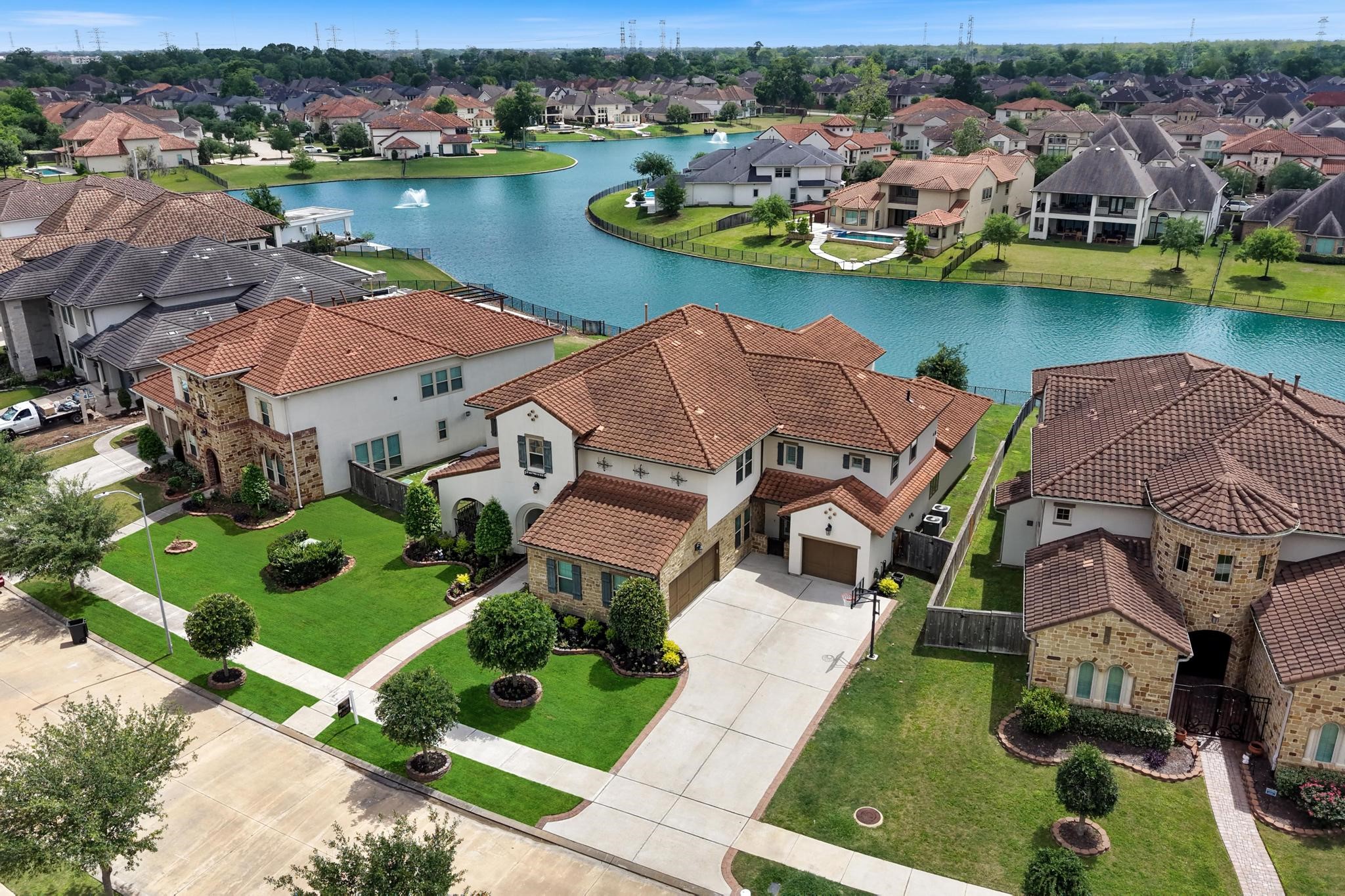 5403 Rouchel Brook Lane Sugar Land, TX 77479 - Photo 2 of 42 Custom Darling Lakefront home in the gated community of Avalon at Riverstone, featuring a 3-car garage and an extended driveway for added convenience.