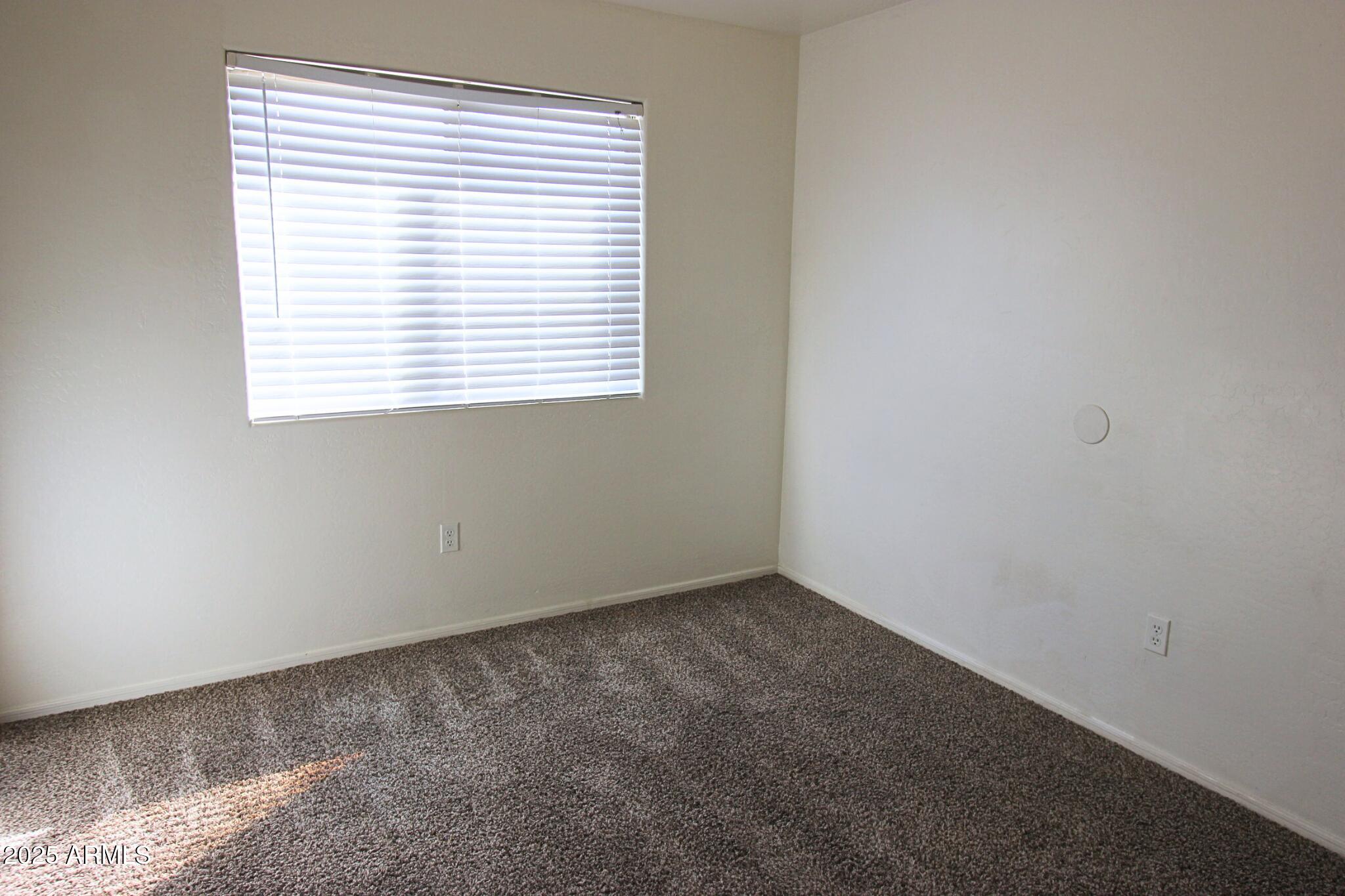13211 South Kin Circle, Unit C Arizona City, AZ 85123 - Photo 12 of 17 an empty room with a window