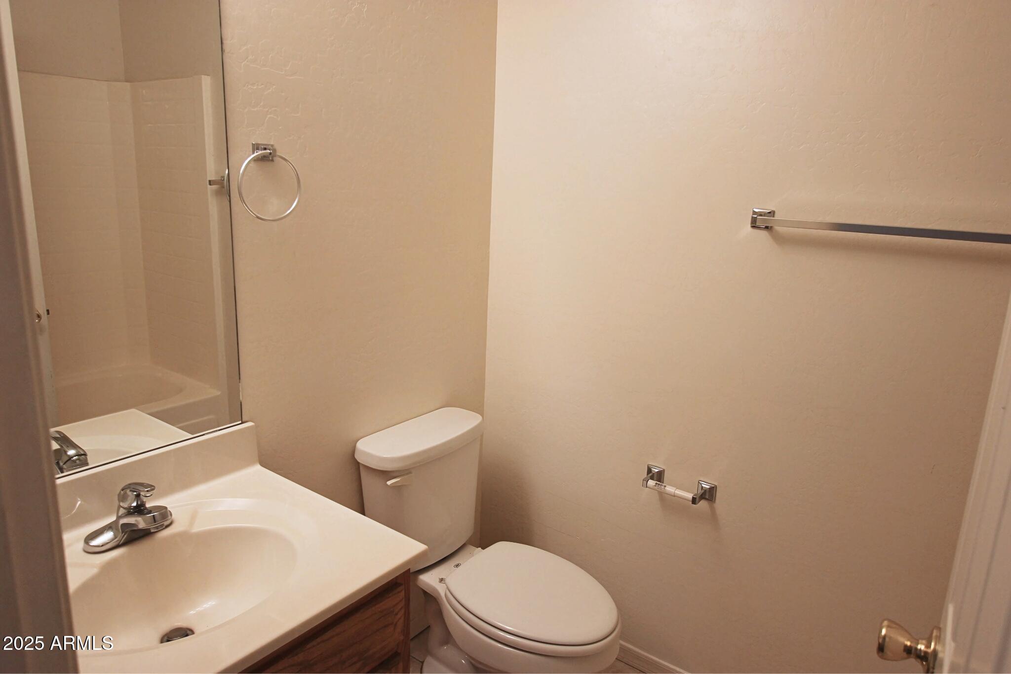 13211 South Kin Circle, Unit C Arizona City, AZ 85123 - Photo 14 of 17 a white toilet sitting next to a bathroom sink