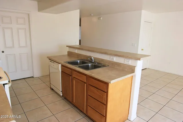 a kitchen that has a sink and a stove in it