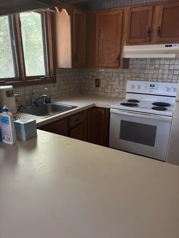 a kitchen with a stove and a sink