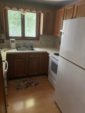 a kitchen with a sink a stove a microwave and a refrigerator