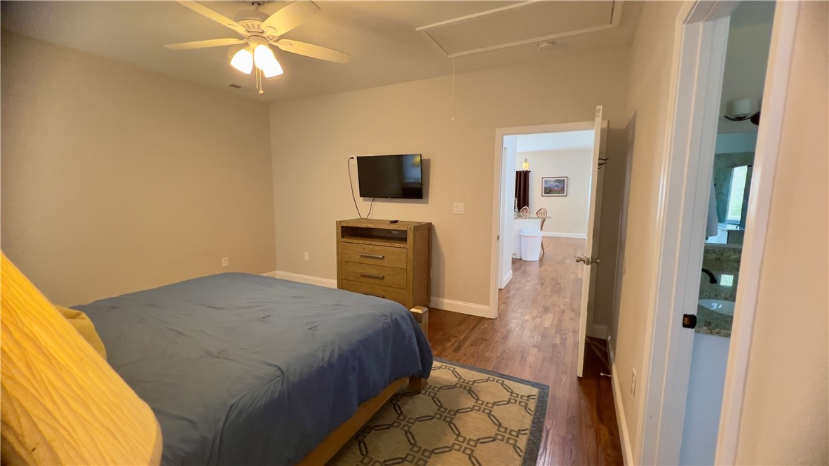 160 Hudgins Lake Road Townville, SC 29689 - Photo 17 of 41 A comfortable bedroom features rich hardwood flooring and a functional ceiling fan.