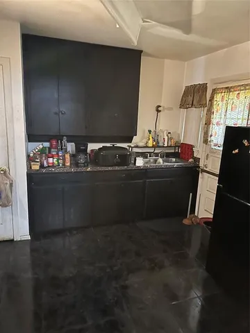 a kitchen with sink cabinets and stainless steel appliances
