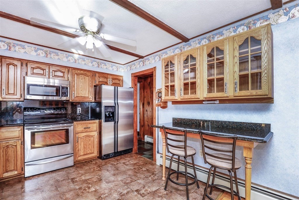 120 Chadwick Road Haverhill, MA 01835 - Photo 11 of 29 a kitchen with stainless steel appliances granite countertop a stove and cabinets