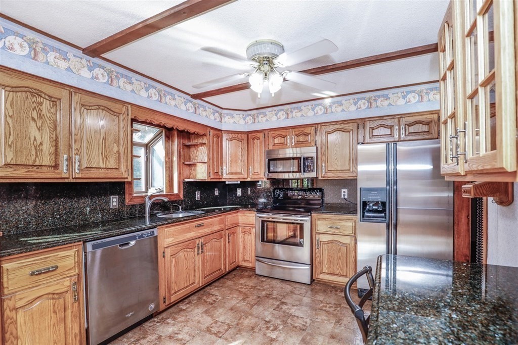 120 Chadwick Road Haverhill, MA 01835 - Photo 12 of 29 a kitchen with stainless steel appliances granite countertop a sink a stove and refrigerator