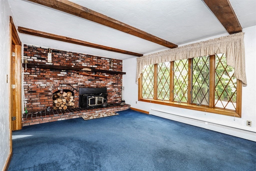 120 Chadwick Road Haverhill, MA 01835 - Photo 14 of 29 a view of an empty room with a fireplace and a window