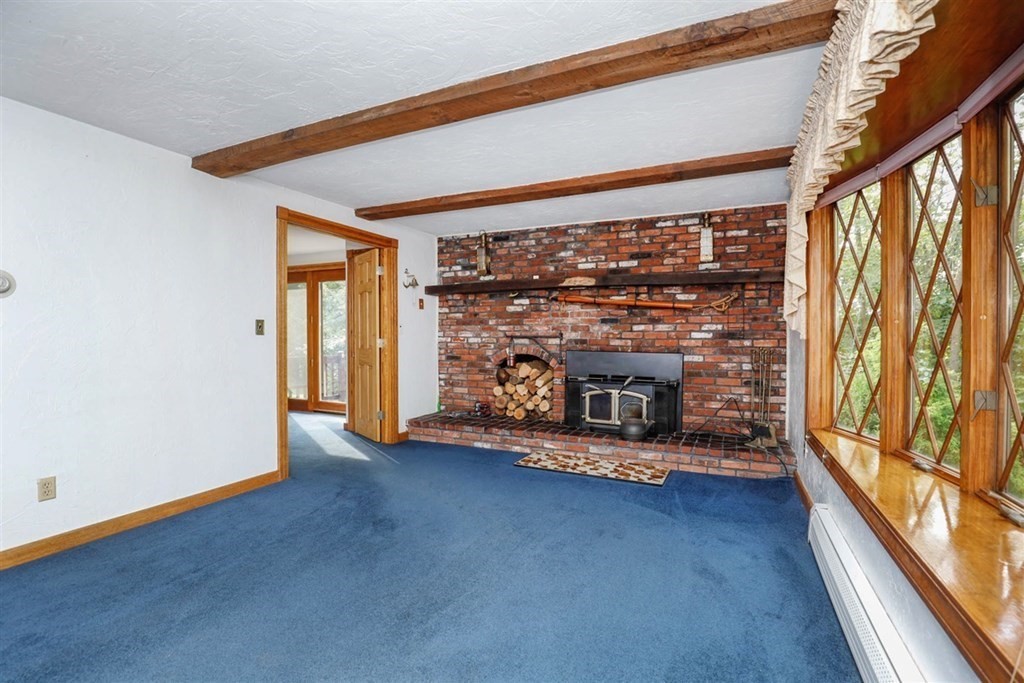 120 Chadwick Road Haverhill, MA 01835 - Photo 15 of 29 an empty room with floor to ceiling windows and fireplace