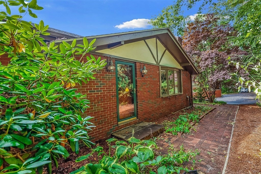 120 Chadwick Road Haverhill, MA 01835 - Photo 3 of 29 a view of a house with brick walls and potted plants