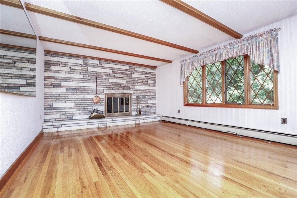 120 Chadwick Road Haverhill, MA 01835 - Photo 4 of 29 a view of empty room with wooden floor and fan