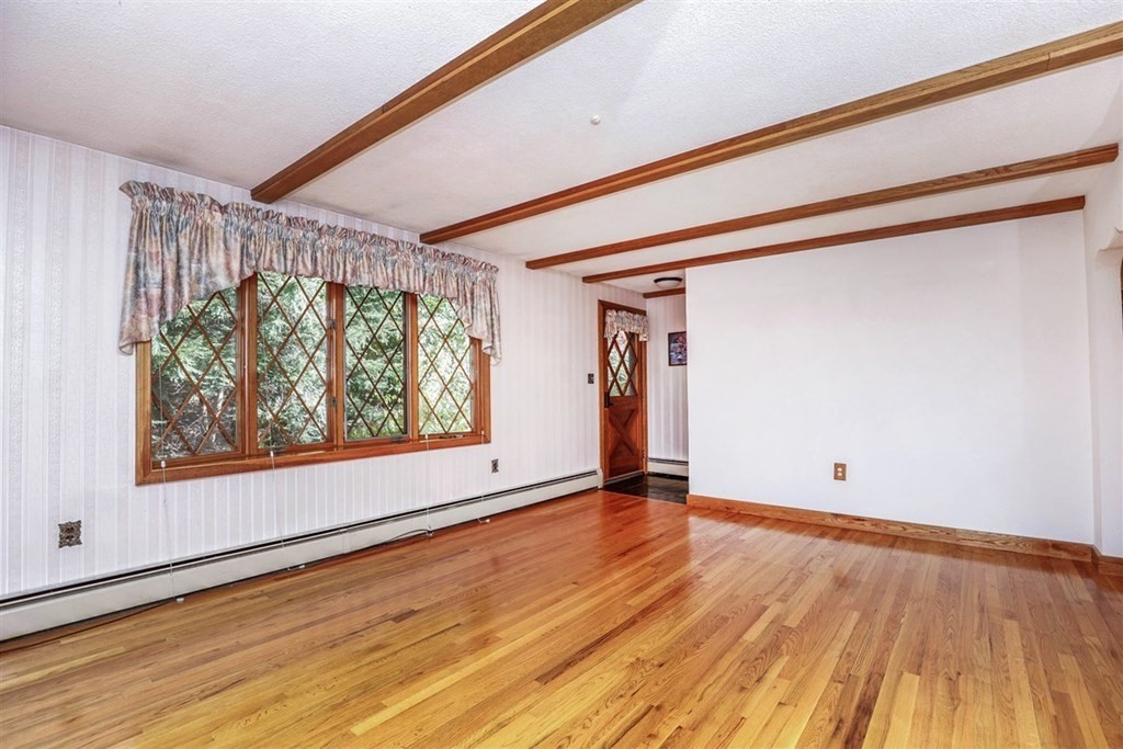 120 Chadwick Road Haverhill, MA 01835 - Photo 5 of 29 a view of an empty room with wooden floor and a window