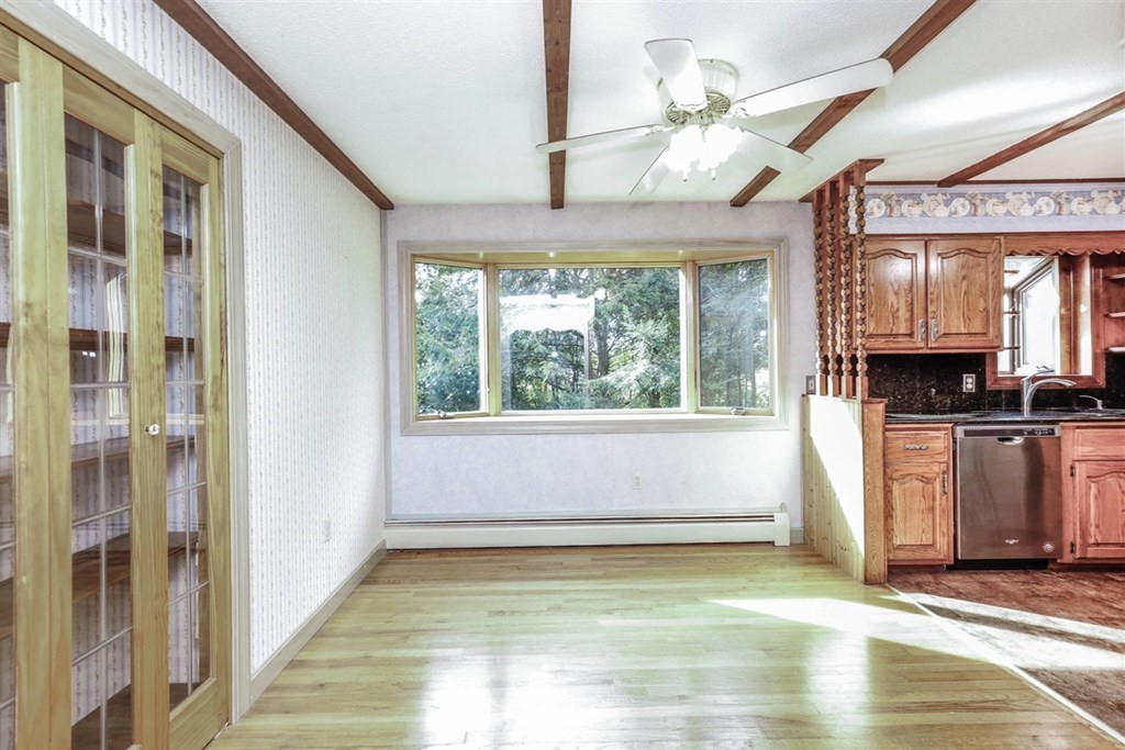 120 Chadwick Road Haverhill, MA 01835 - Photo 7 of 29 a view of an empty room with window and kitchen view