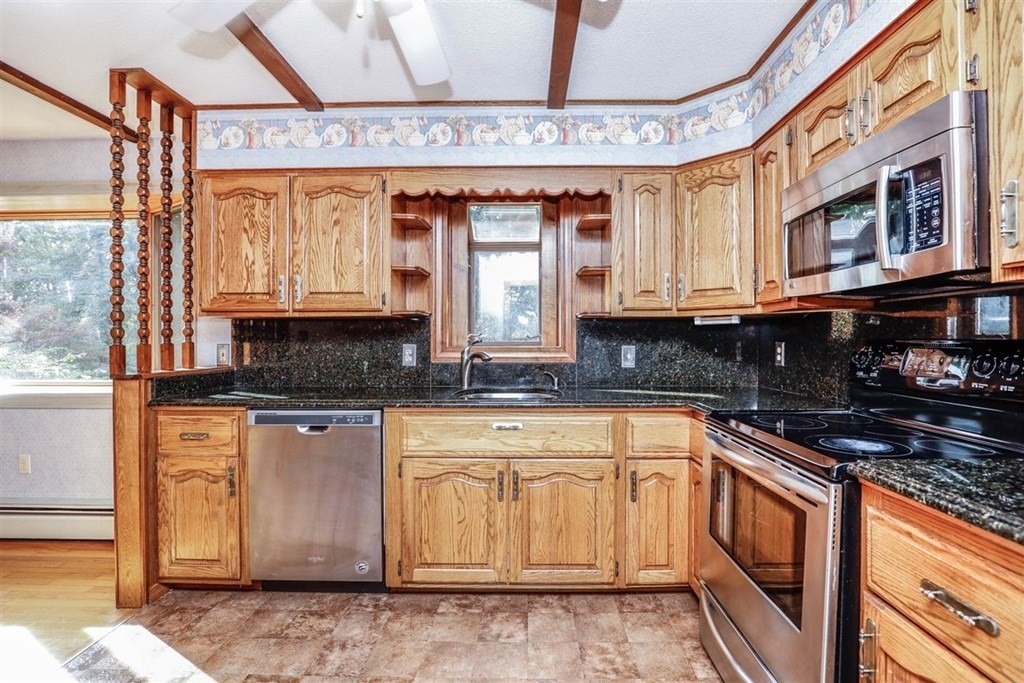 120 Chadwick Road Haverhill, MA 01835 - Photo 10 of 29 a kitchen with stainless steel appliances granite countertop a stove a sink and a microwave