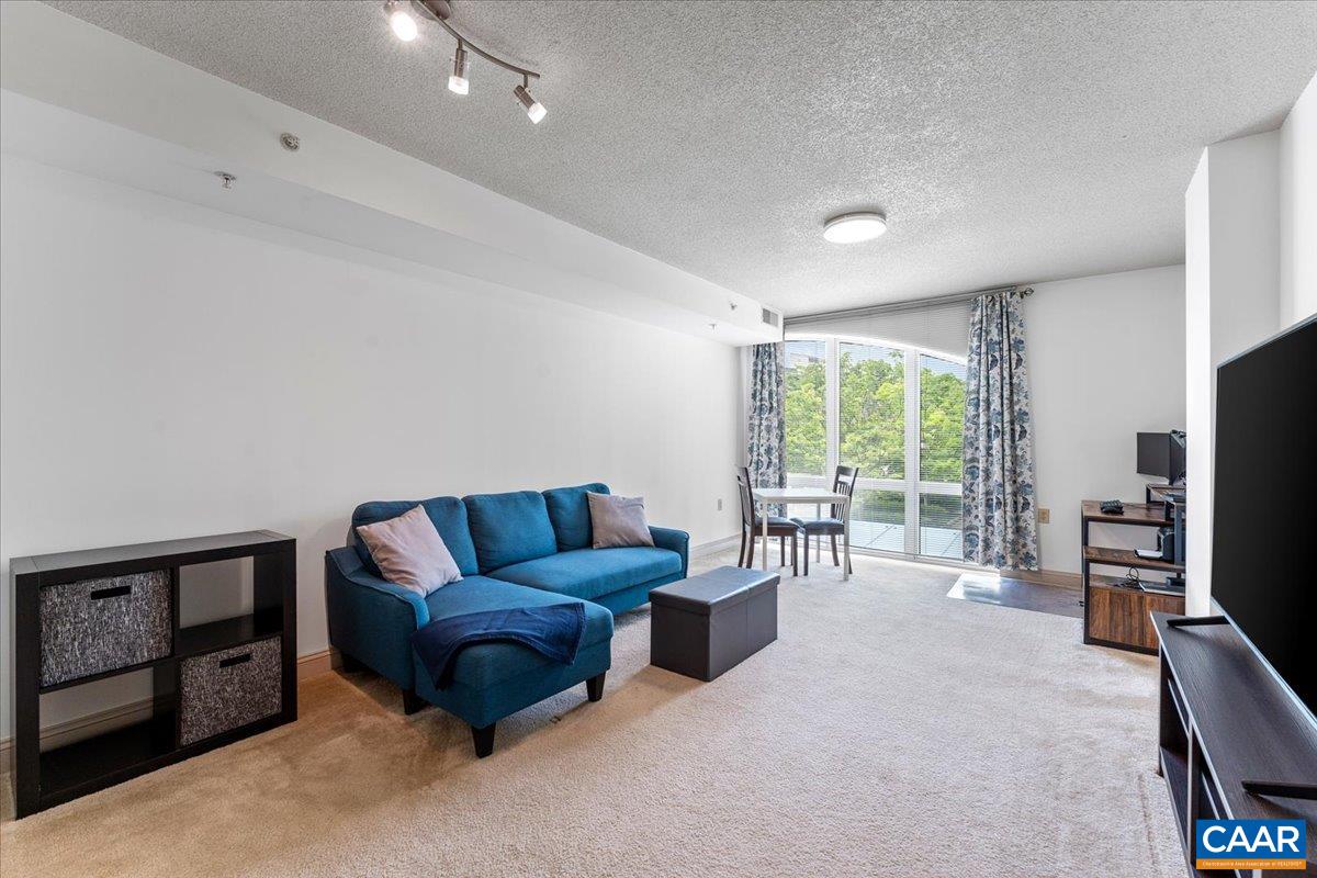 11760 Sunrise Valley Drive, Unit 208 Reston, VA 20191 - Photo 11 of 30 a living room with furniture and a flat screen tv