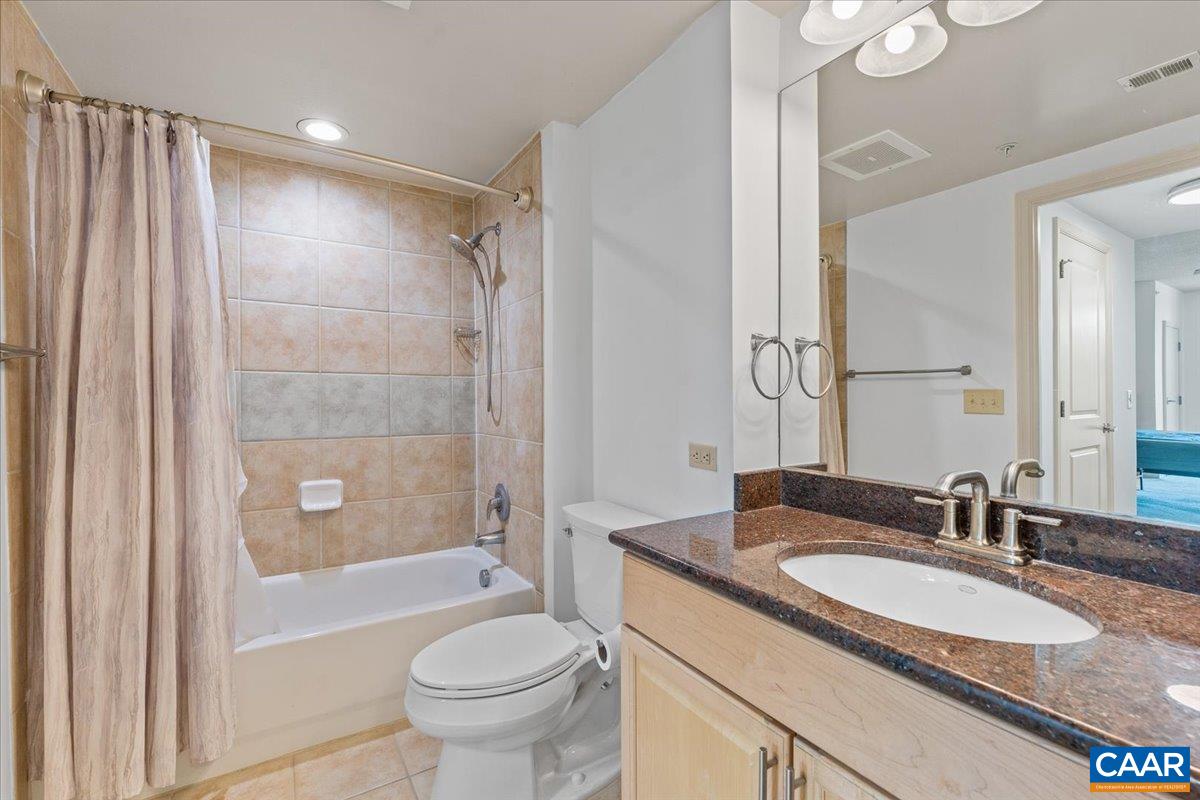 11760 Sunrise Valley Drive, Unit 208 Reston, VA 20191 - Photo 15 of 30 a bathroom with a granite countertop sink toilet and shower
