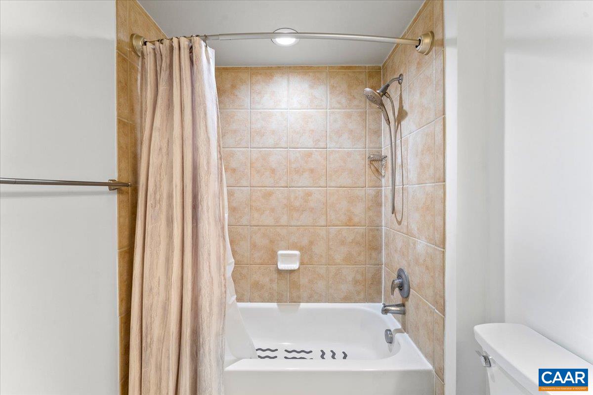 11760 Sunrise Valley Drive, Unit 208 Reston, VA 20191 - Photo 16 of 30 a bathroom with a shower and a toilet