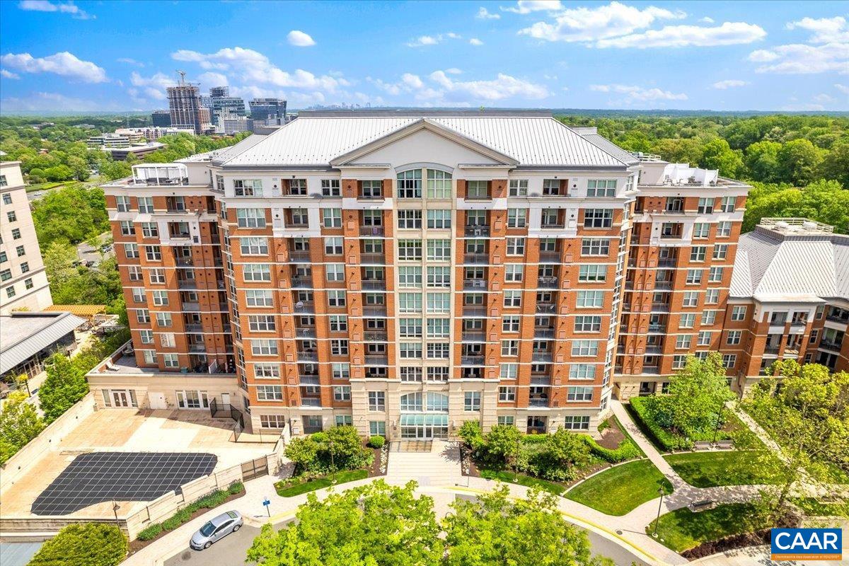 11760 Sunrise Valley Drive, Unit 208 Reston, VA 20191 - Photo 2 of 30 a front view of a building with a garden