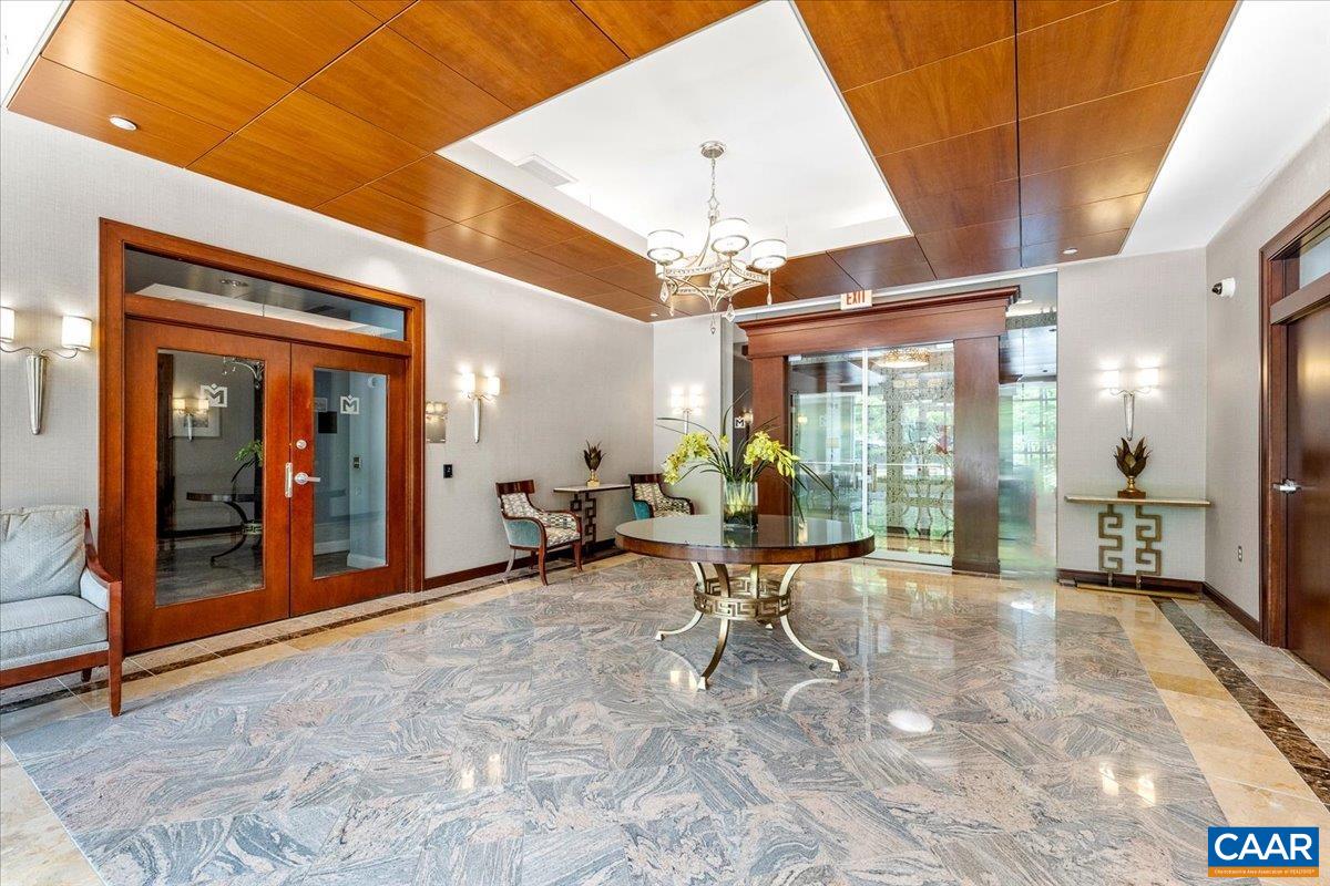 11760 Sunrise Valley Drive, Unit 208 Reston, VA 20191 - Photo 4 of 30 a view of a hall with dining area and chandelier