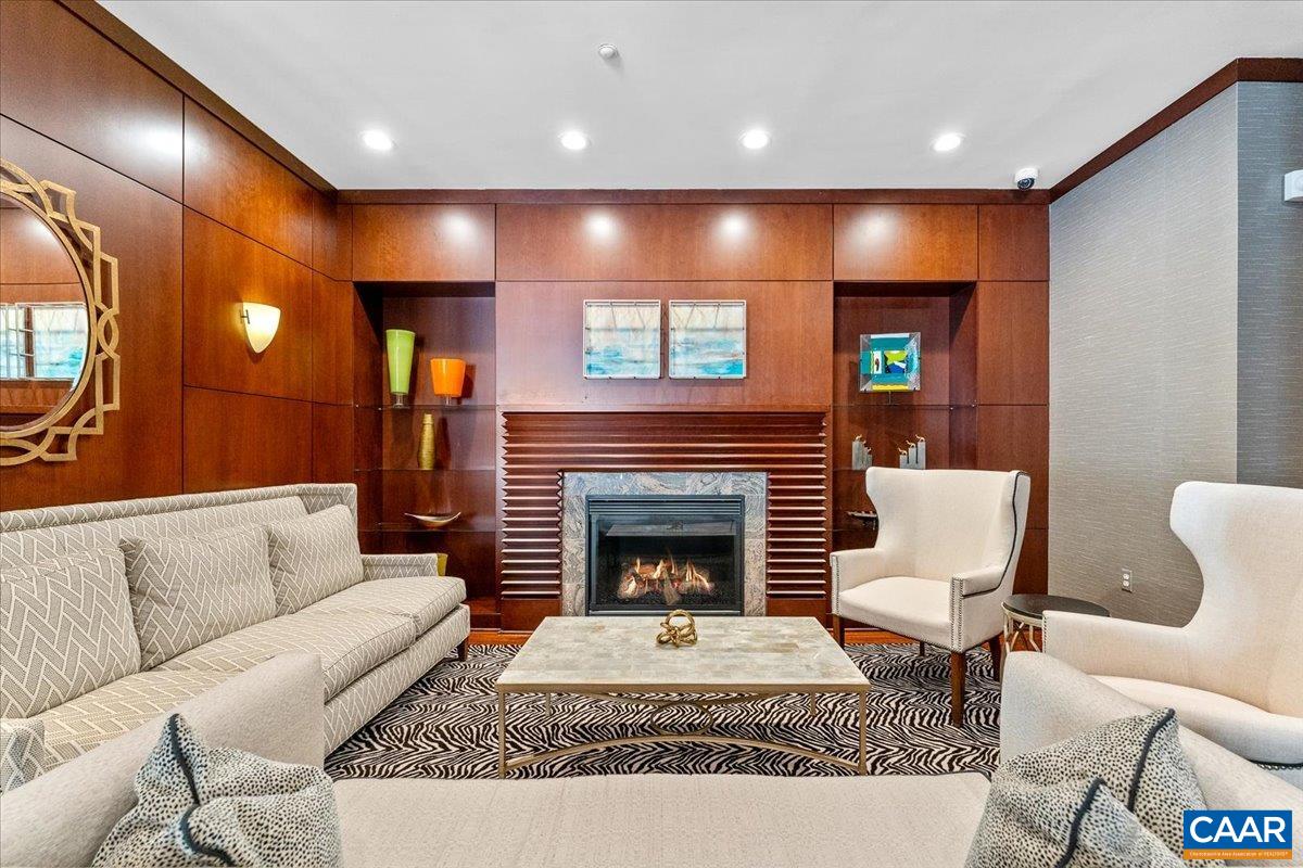 11760 Sunrise Valley Drive, Unit 208 Reston, VA 20191 - Photo 6 of 30 a living room with furniture a flat screen tv and a fireplace