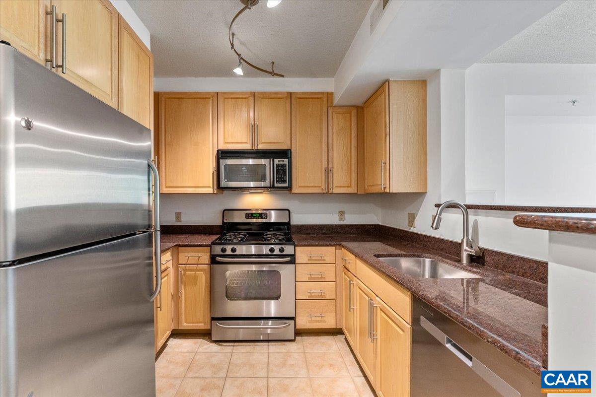 11760 Sunrise Valley Drive, Unit 208 Reston, VA 20191 - Photo 8 of 30 a kitchen with a sink appliances and cabinets