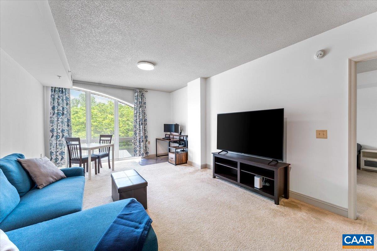 11760 Sunrise Valley Drive, Unit 208 Reston, VA 20191 - Photo 10 of 30 a living room with furniture and a flat screen tv