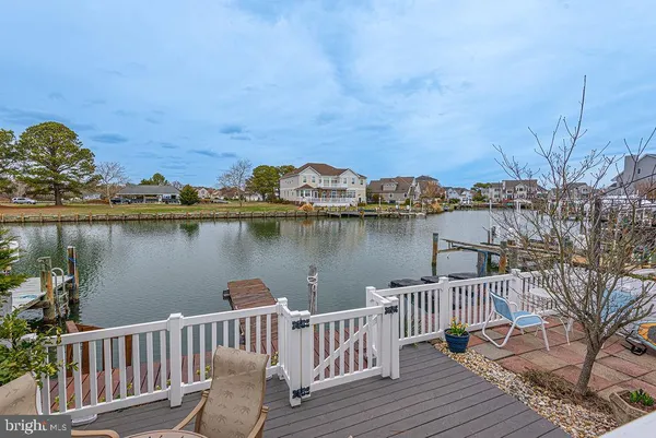 a view of a hallway with wooden floor and dining room view