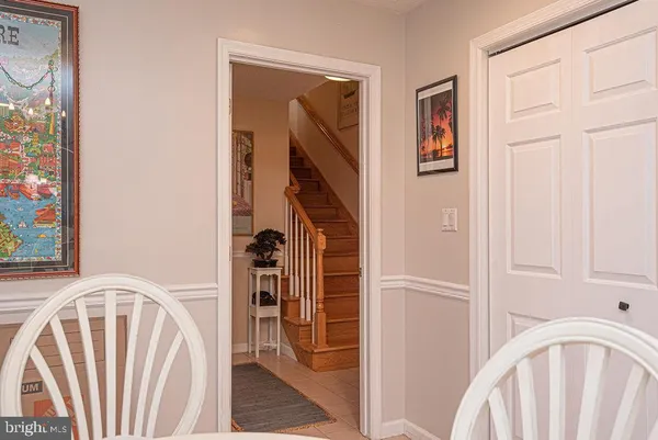 a view of a hallway with furniture and a painting on the wall