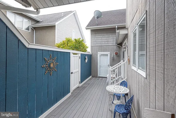 a dining room with furniture wooden floor a rug and a chandelier