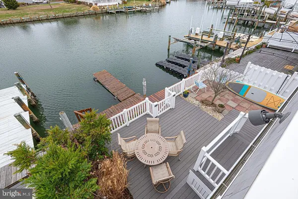 a kitchen with stainless steel appliances kitchen island granite countertop a sink refrigerator and cabinets