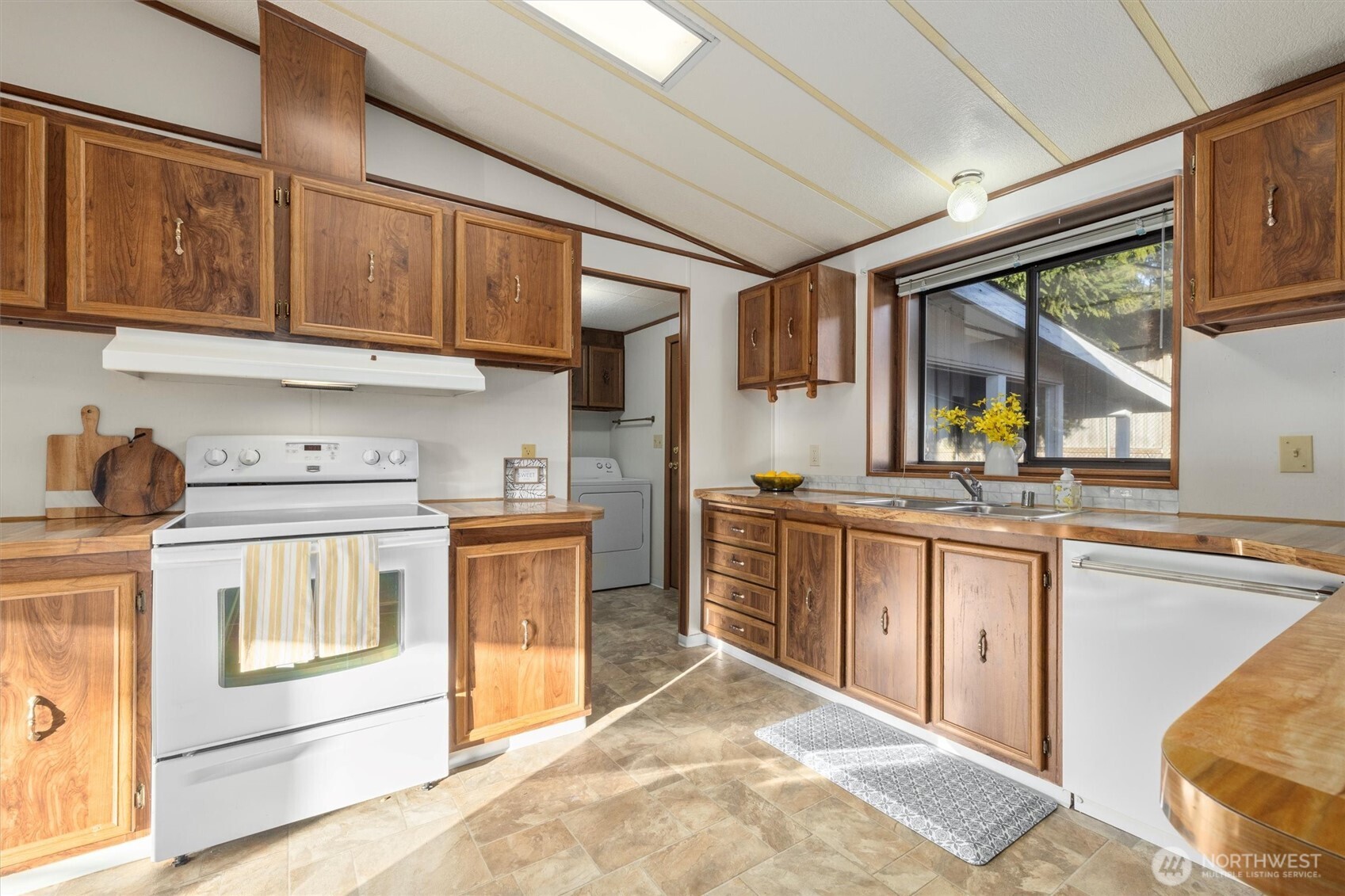 24331 S Park Bothell, WA 98021 - Photo 16 of 40 a kitchen with stainless steel appliances granite countertop a stove a sink dishwasher and a refrigerator with wooden cabinets