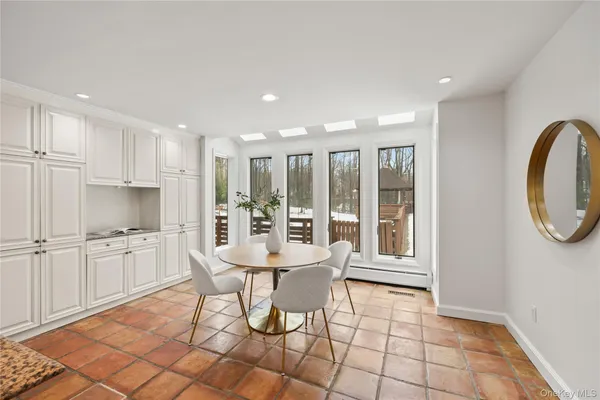 a large white kitchen with a sink and cabinets