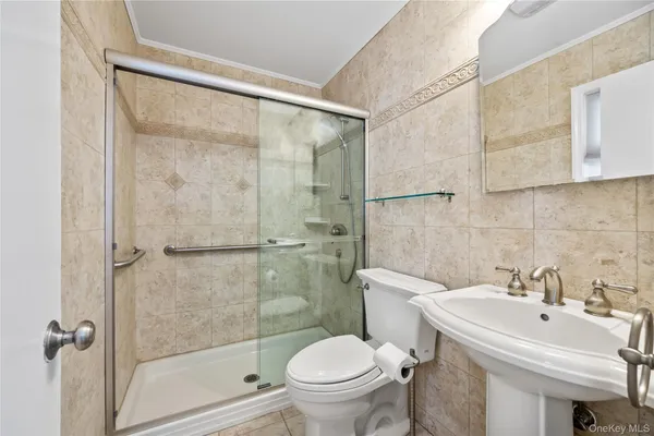 a bathroom with a sink toilet and shower