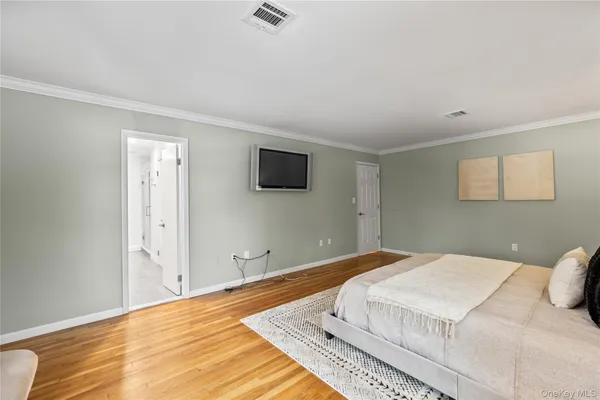 a bedroom with a bed and a night stand