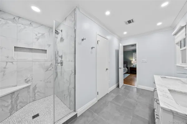 a bathroom with a tub shower and a sink