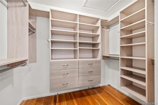 a view of walk in closet with empty racks