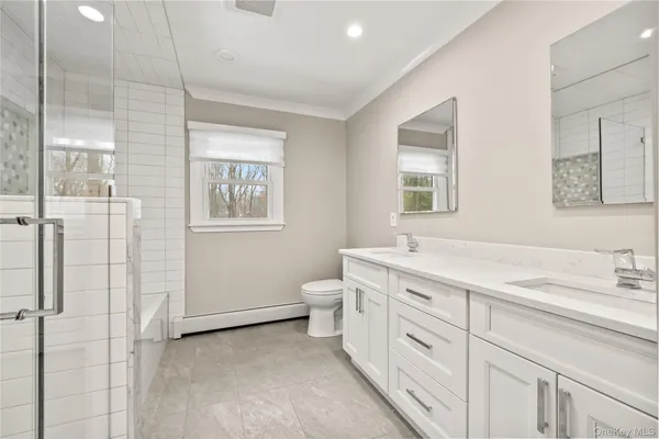 a spacious bathroom with a granite countertop sink a toilet and a mirror