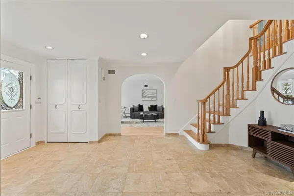 a view of a hallway with entryway wooden floor and front door